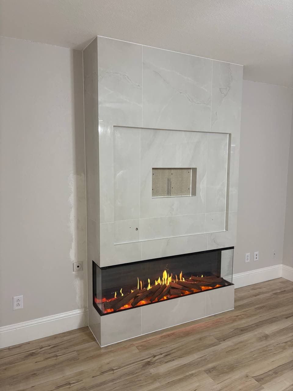 Completed fireplace tile surround with electric insert in Dallas TX