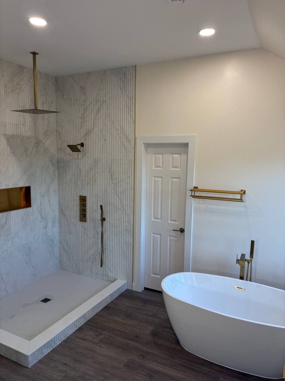 Luxury master bathroom with walk-in shower and freestanding tub in Prosper TX