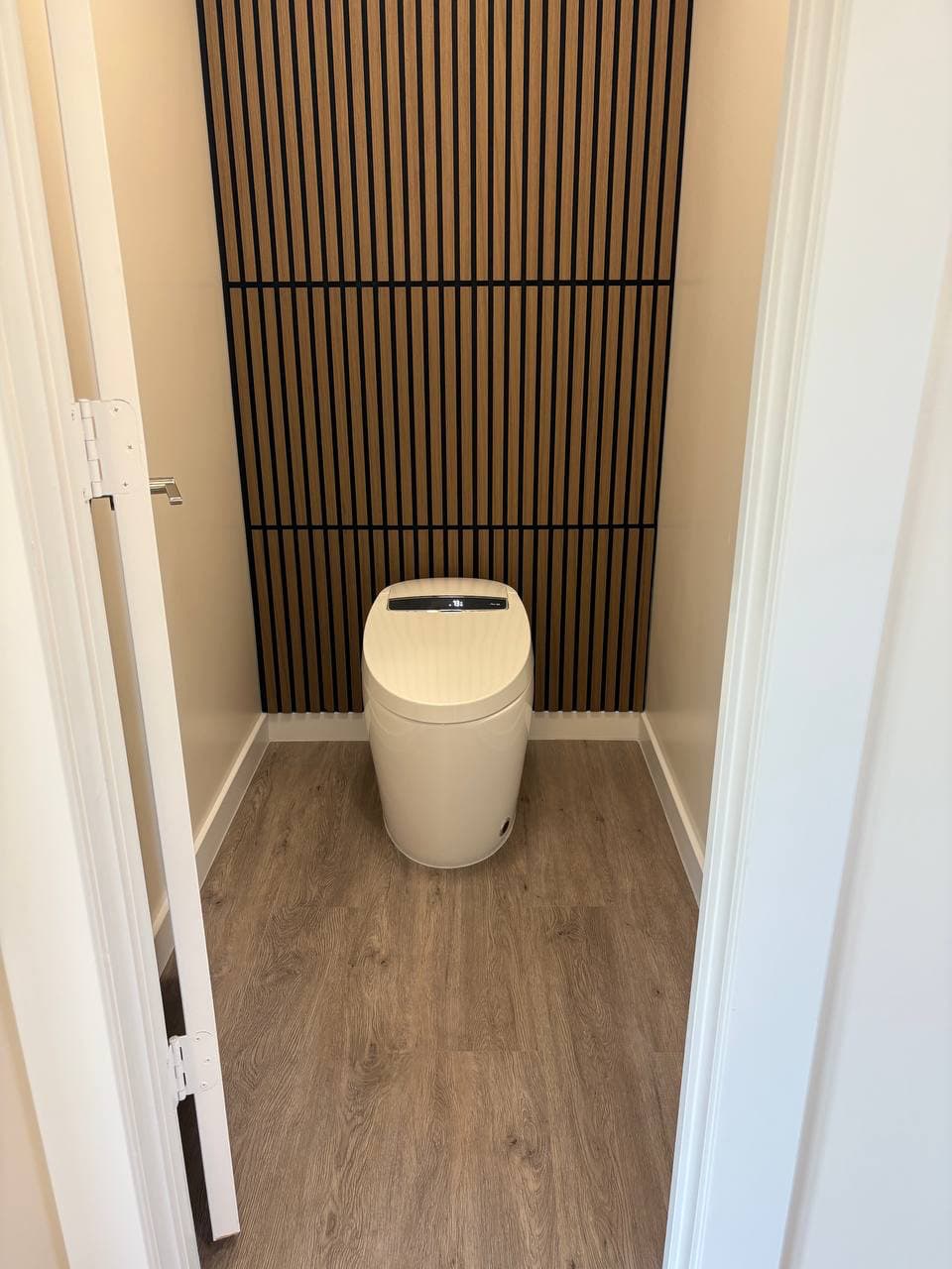 Modern bathroom with wood slat accent wall and custom tile in Richardson TX